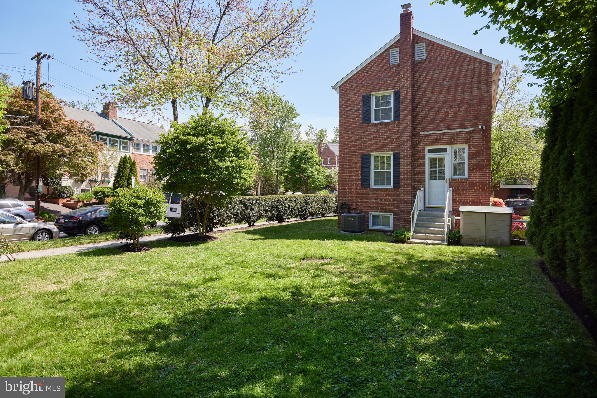 3501 Alton Place Northwest Washington, DC 20008 - Photo 25 of 29 a front view of a house with a yard and trees