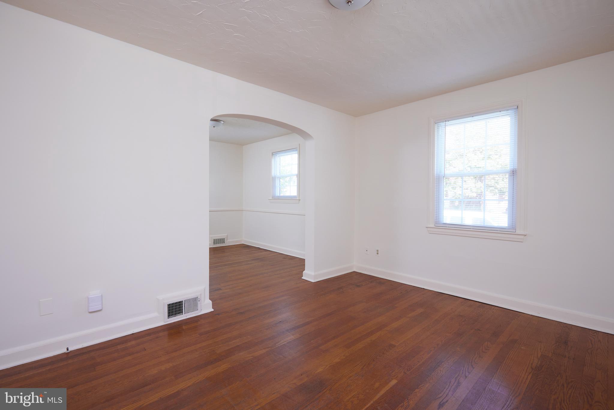 3501 Alton Place Northwest Washington, DC 20008 - Photo 5 of 29 an empty room with wooden floor and windows