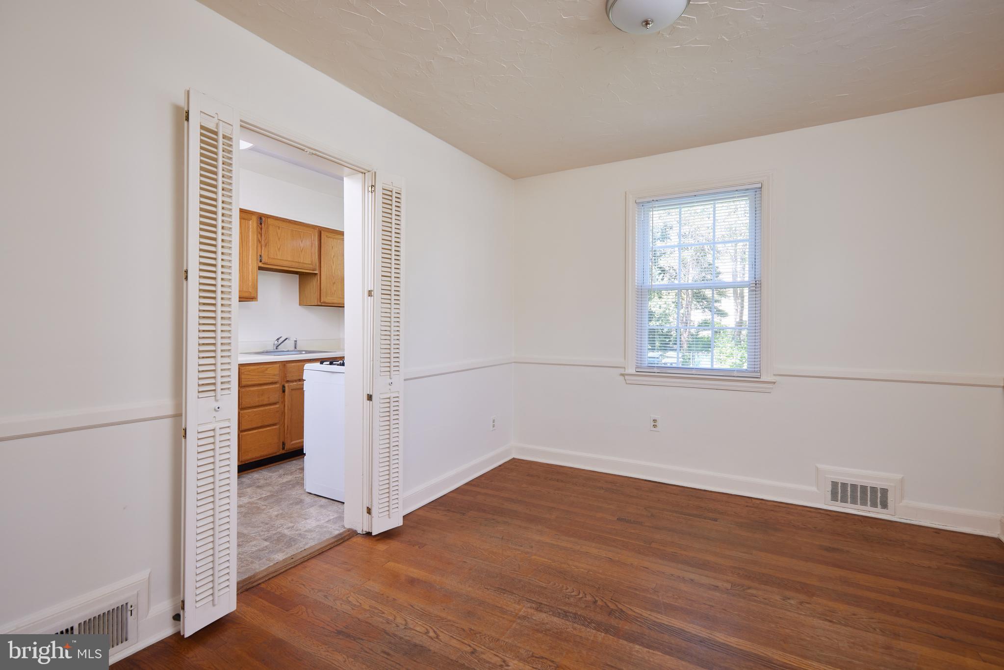 3501 Alton Place Northwest Washington, DC 20008 - Photo 8 of 29 an empty room with wooden floor and a window