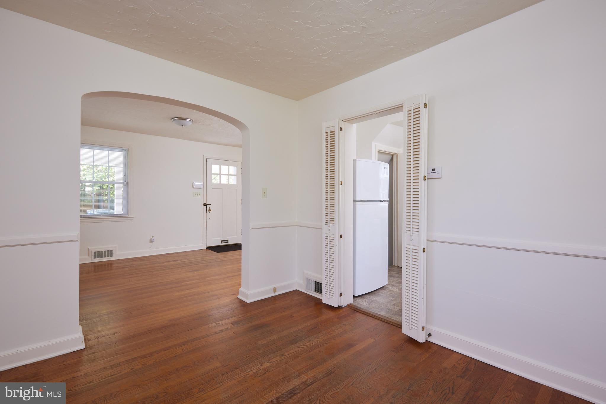 3501 Alton Place Northwest Washington, DC 20008 - Photo 9 of 29 an empty room with wooden floor and windows