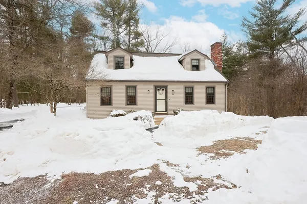 a view of a white house with a yard covered in snow