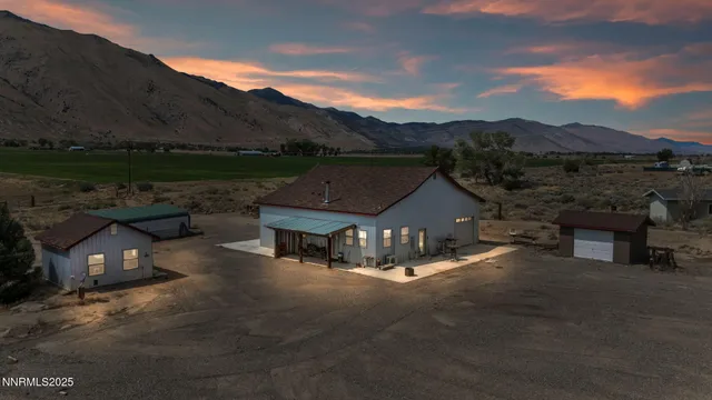 a view of a house with a yard and sitting area