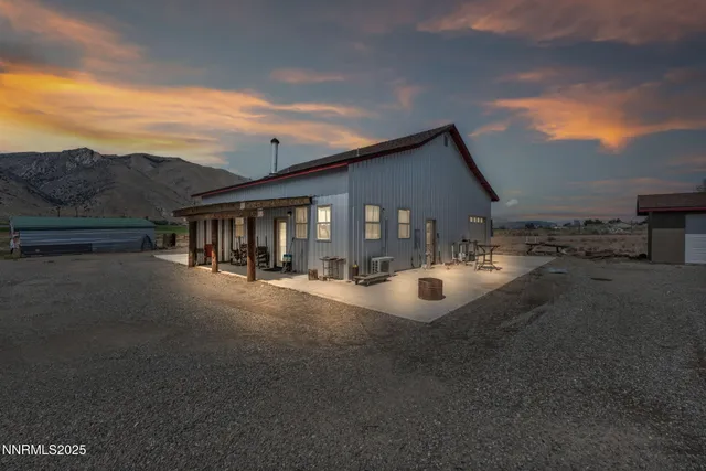a view of a house with backyard and a patio