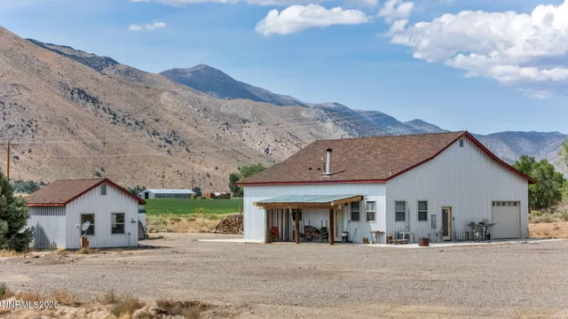 a front view of a house with a mountain in the background