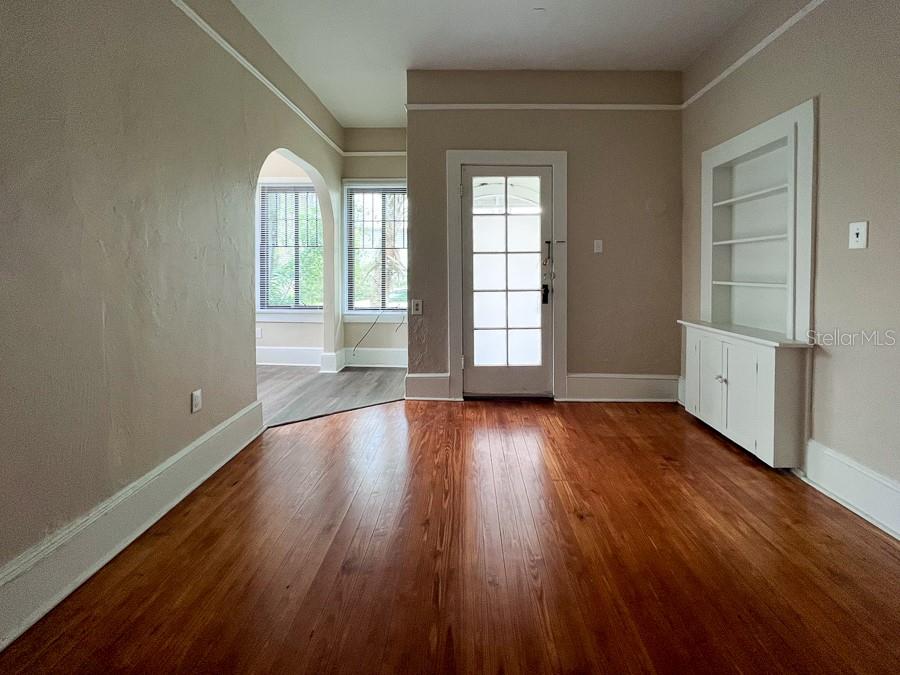 208 Northeast 4 Street Gainesville, FL 32601 - Photo 15 of 17 an empty room with wooden floor and windows
