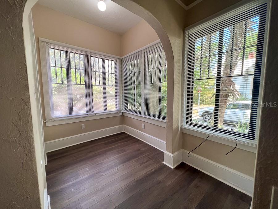 208 Northeast 4 Street Gainesville, FL 32601 - Photo 5 of 17 a view of an empty room with wooden floor and a window