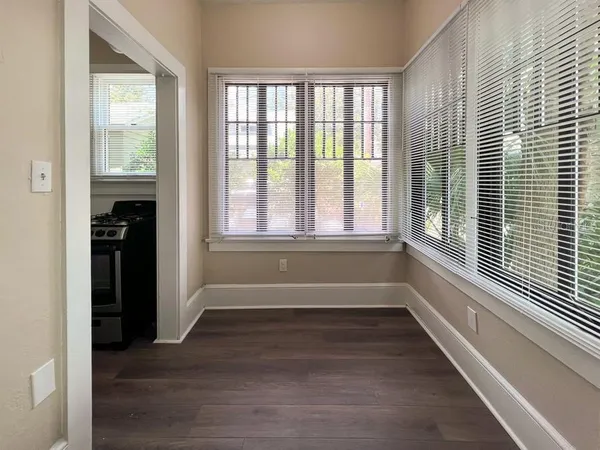 a view of a room with wooden floor and a window