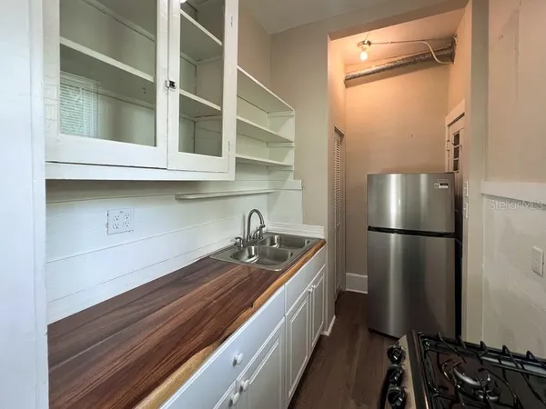 a kitchen with a refrigerator and a sink