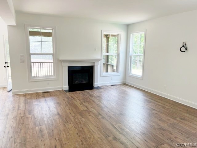 9249 Moldova Road Chesterfield, VA 23832 - Photo 5 of 22 an empty room with wooden floor fireplace and windows