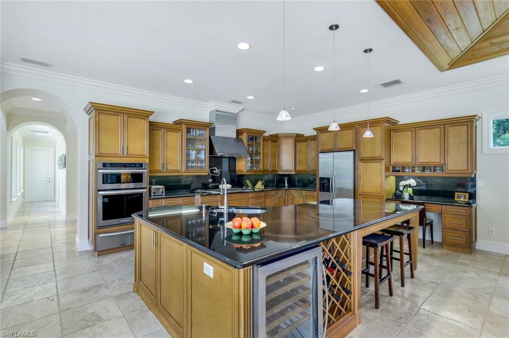 1284 Pocantico Lane Naples, FL 34110 - Photo 17 of 50 Chef's Island Kitchen w/ Counter Height Seating