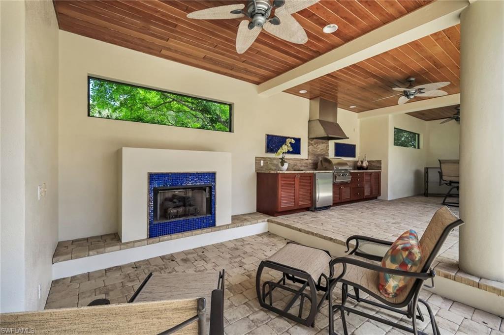 1284 Pocantico Lane Naples, FL 34110 - Photo 27 of 50 Fireplace Outdoors w/ Wood-Paneled Ceiling