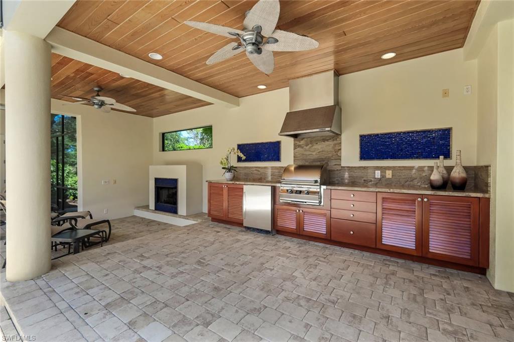 1284 Pocantico Lane Naples, FL 34110 - Photo 28 of 50 Portico w/ Granite-Topped Poolside Kitchen