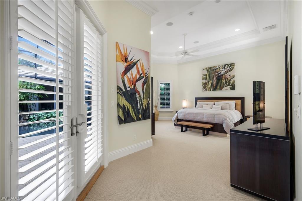 1284 Pocantico Lane Naples, FL 34110 - Photo 32 of 50 Owner's Suite w/ French Doors to Lanai & Two XL Custom Walk-In Closets