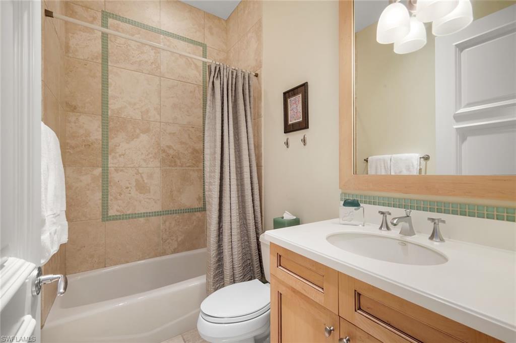 1284 Pocantico Lane Naples, FL 34110 - Photo 38 of 50 En-Suite Bath w. Custom Vanity/Mirror & Tub-Shower Stone Tile to Ceiling