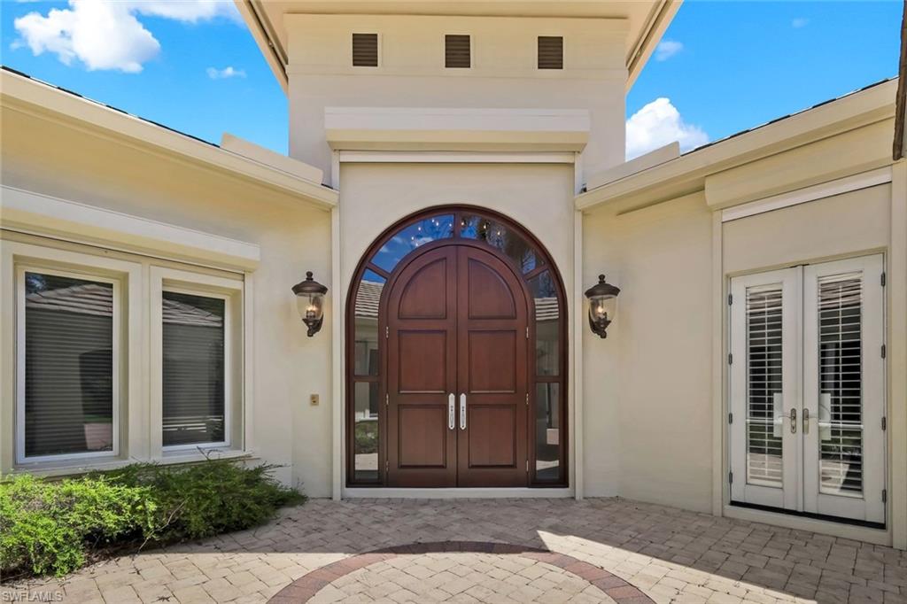 1284 Pocantico Lane Naples, FL 34110 - Photo 4 of 50 Custom Mahogany Doors off the Entry Courtyard Set a Tone of Luxury