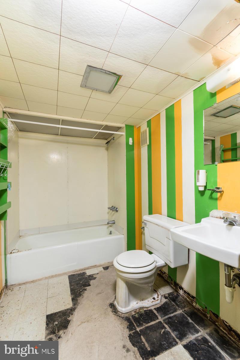 4757 Bonnie Brae Road Pikesville, MD 21208 - Photo 22 of 30 a bathroom with a sink a toilet a mirror and bathtub
