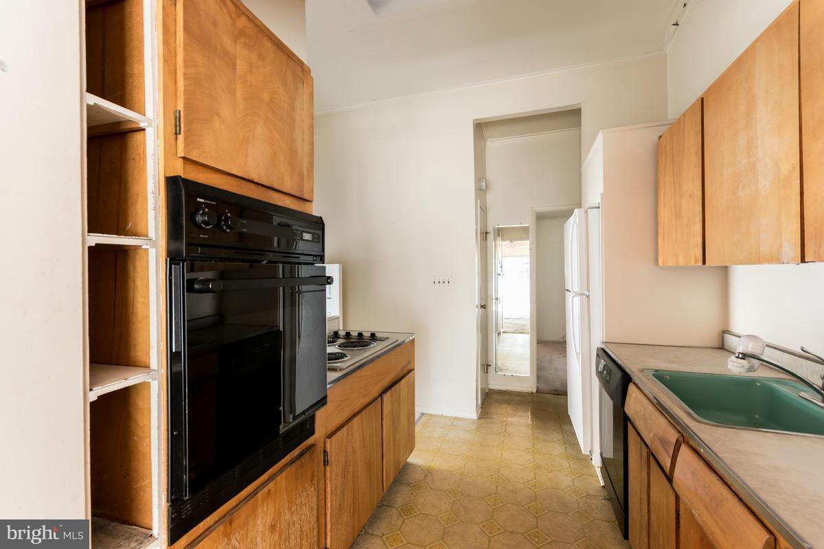4757 Bonnie Brae Road Pikesville, MD 21208 - Photo 8 of 30 a kitchen with a refrigerator and a sink