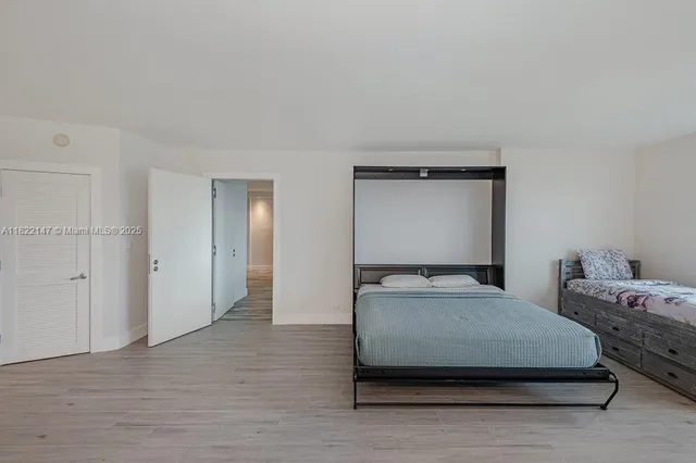 a bedroom with a bed and a mirror