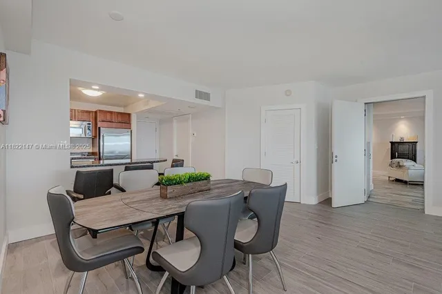 a kitchen with stainless steel appliances granite countertop a sink and a refrigerator