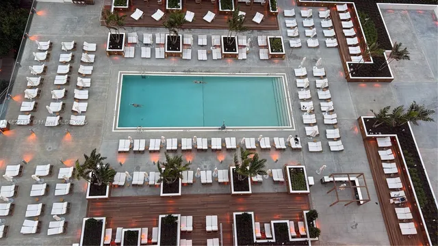 a view of a swimming pool with a yard