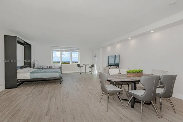 a living room with furniture a wooden floor and a sink