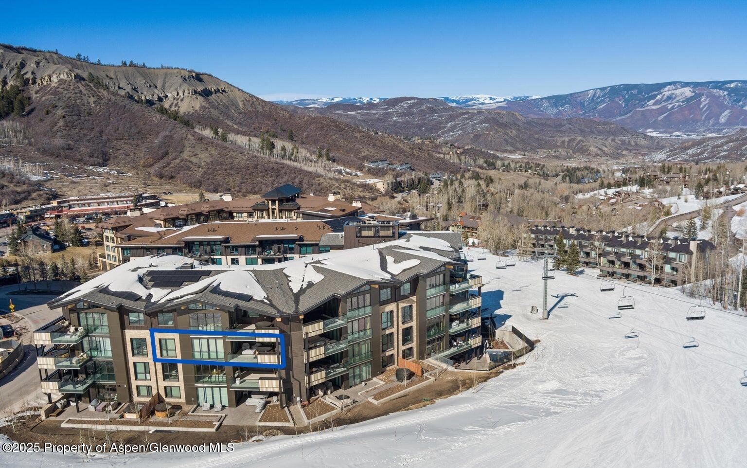 180 Wood Road, Unit 404 Snowmass Village, CO 81615 - Photo 24 of 51 a view of a town with mountains in the background