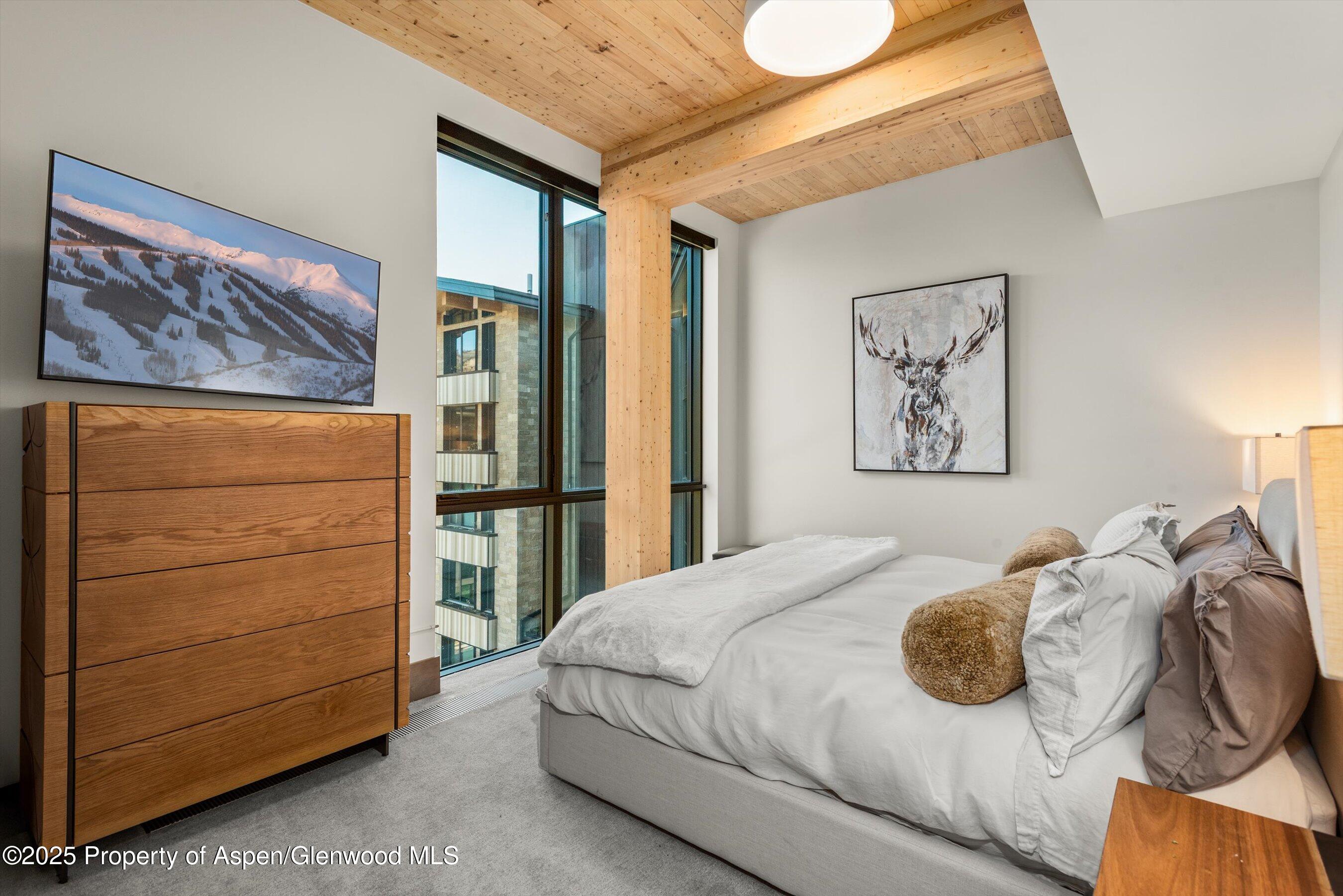 180 Wood Road, Unit 404 Snowmass Village, CO 81615 - Photo 10 of 51 404 2nd bedroom with Samung smart TVa