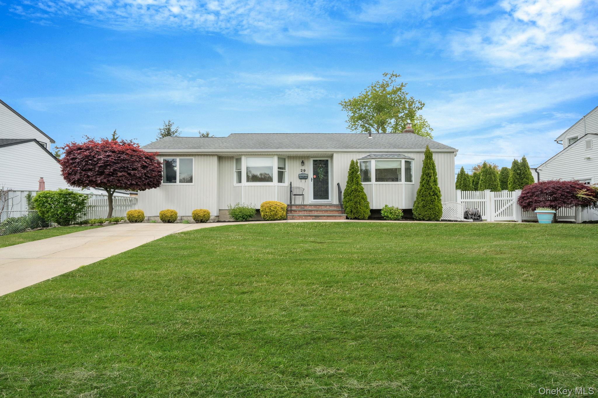 29 Franklin Street Islip, NY 11751 - Photo 1 of 39 a front view of a house with a yard and potted plants
