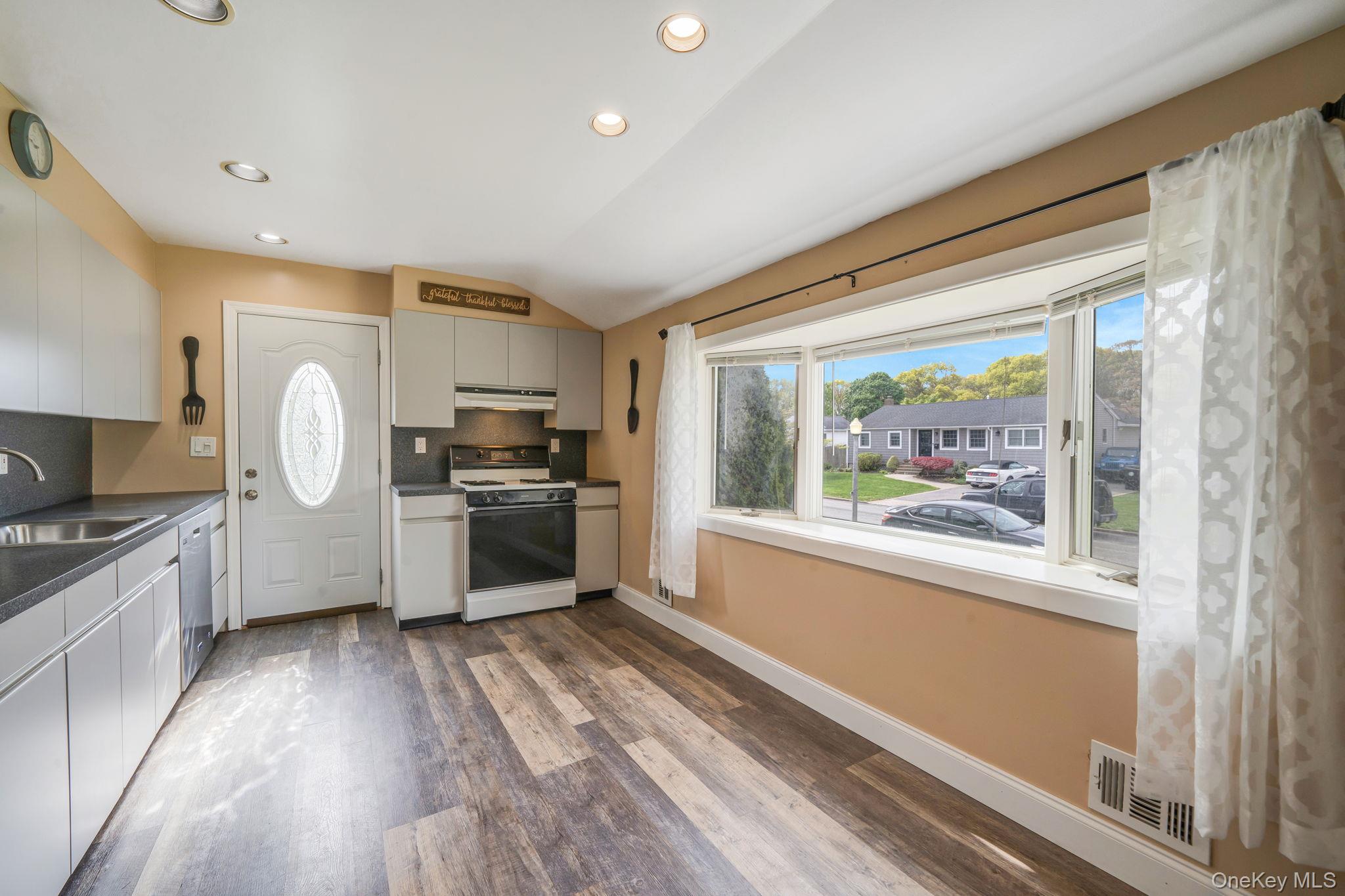 29 Franklin Street Islip, NY 11751 - Photo 11 of 39 a kitchen with granite countertop a stove a sink and a refrigerator