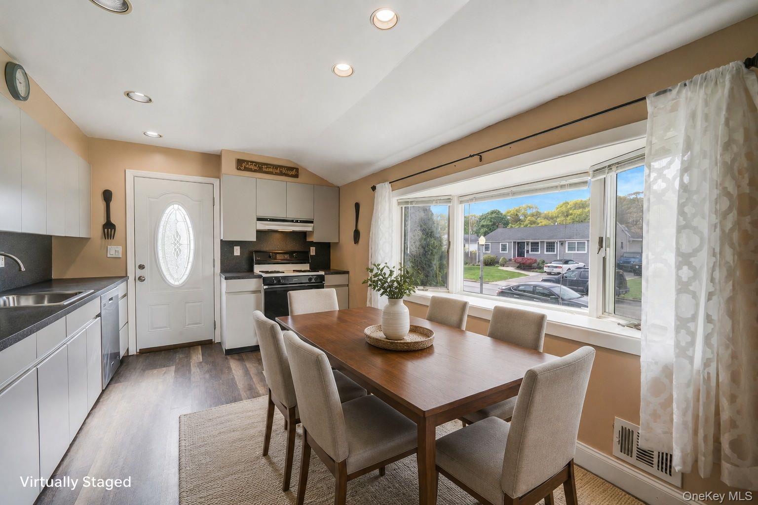 29 Franklin Street Islip, NY 11751 - Photo 12 of 39 a kitchen with a table chairs microwave and cabinets