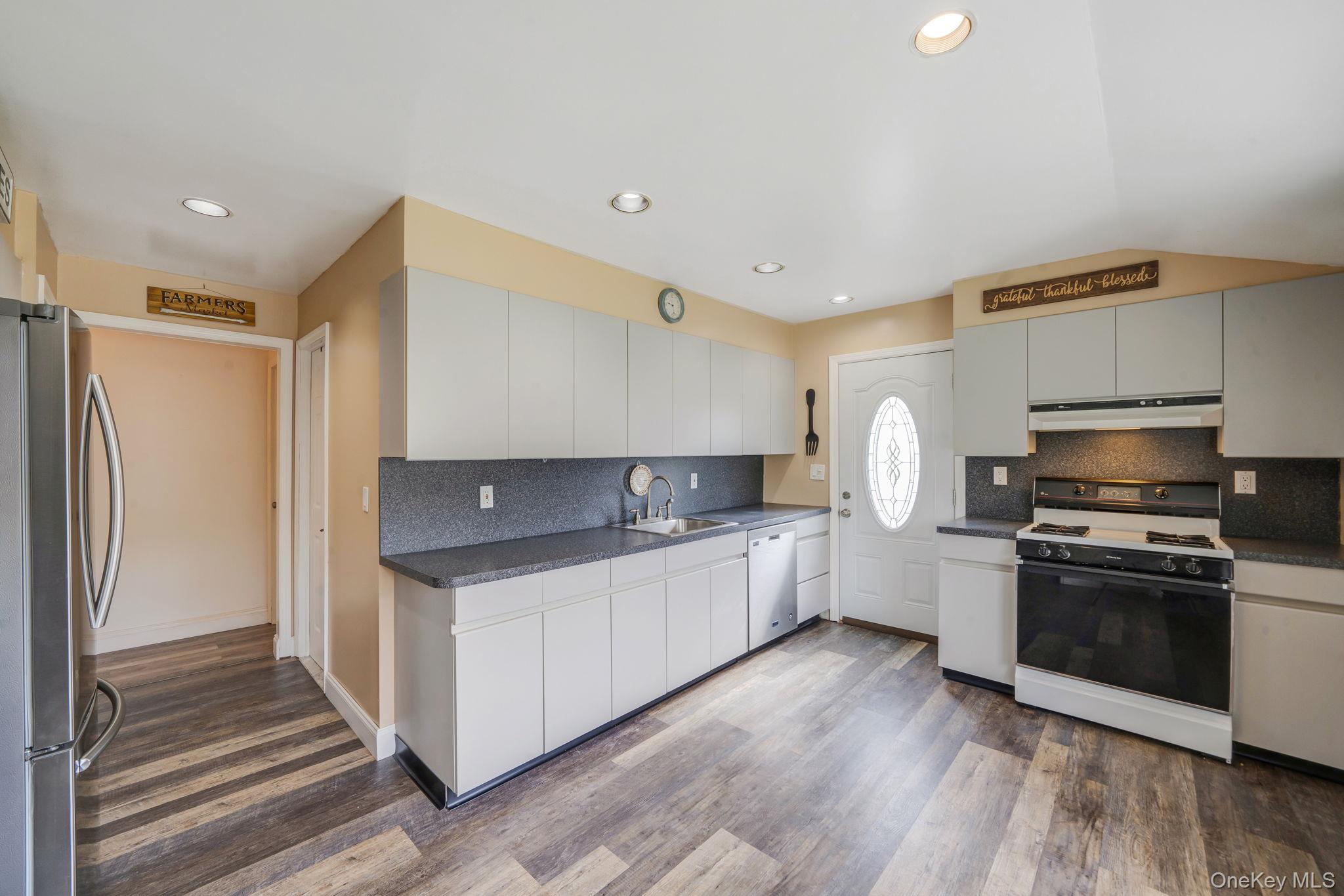 29 Franklin Street Islip, NY 11751 - Photo 13 of 39 a kitchen with stainless steel appliances a sink stove and refrigerator