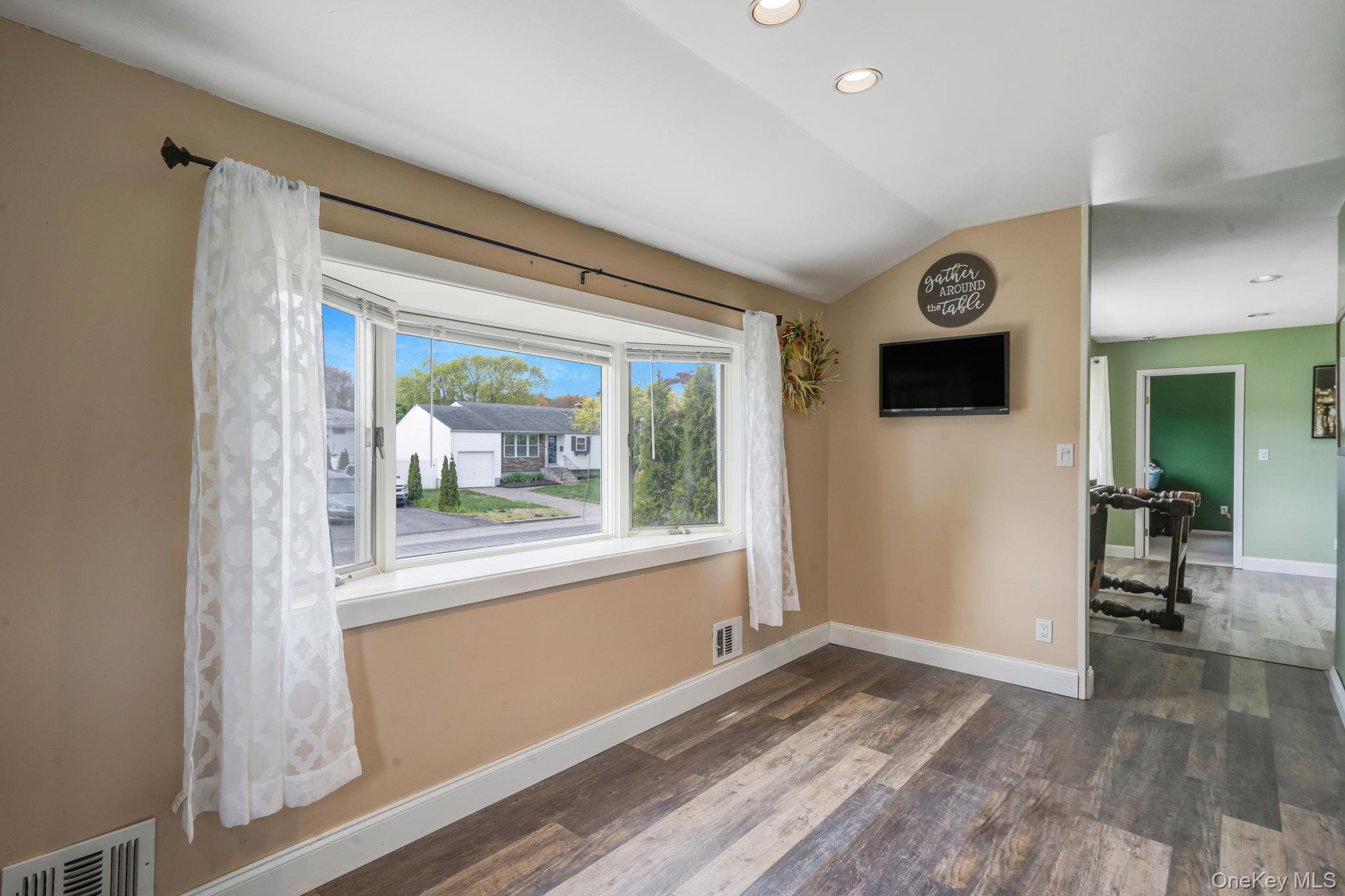 29 Franklin Street Islip, NY 11751 - Photo 15 of 39 a view of empty room with wooden floor and fan