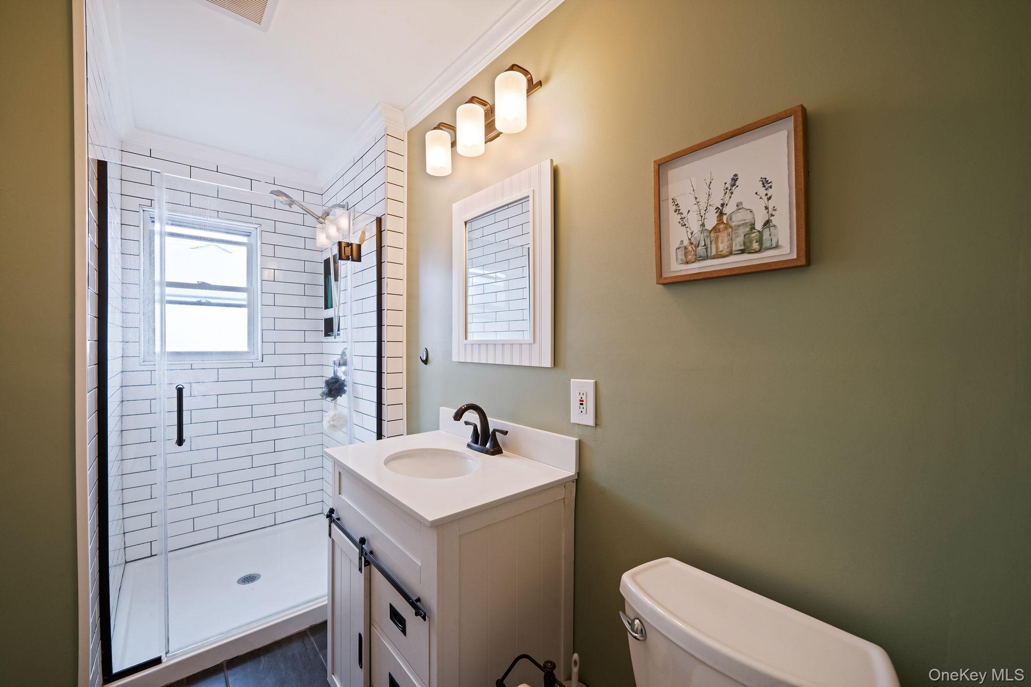 29 Franklin Street Islip, NY 11751 - Photo 16 of 39 a bathroom with a sink mirror vanity and toilet