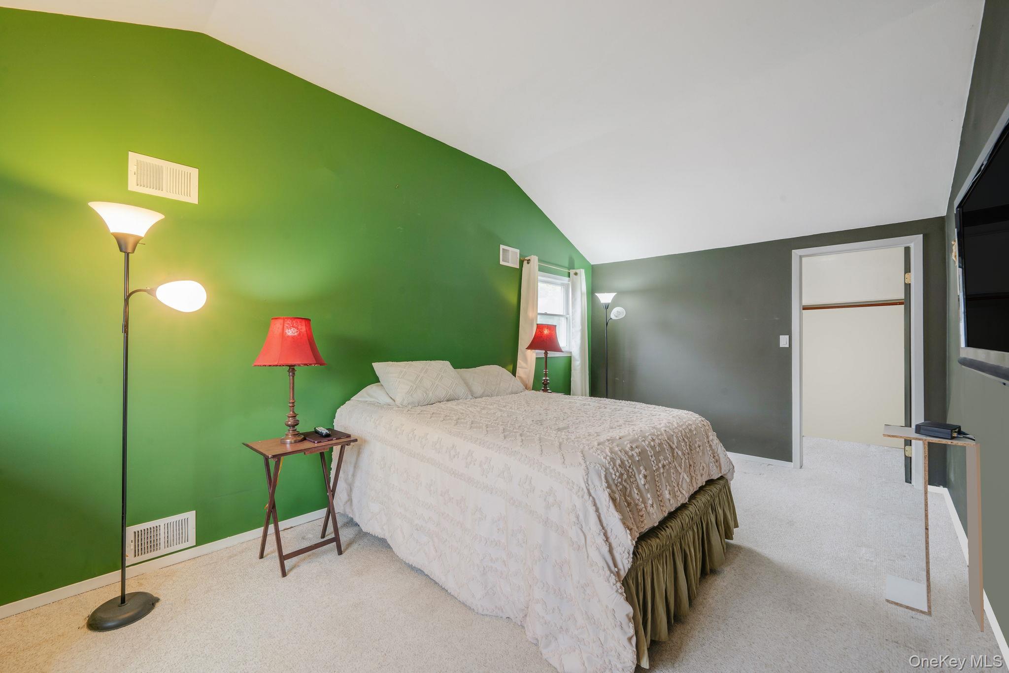 29 Franklin Street Islip, NY 11751 - Photo 17 of 39 a spacious bedroom with a bed and a chandelier