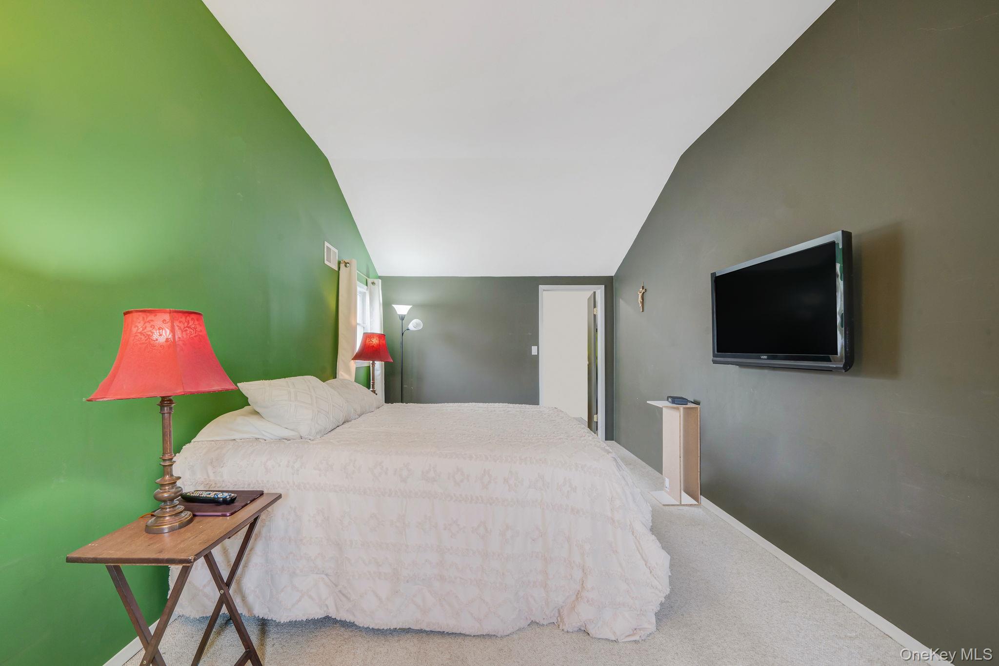 29 Franklin Street Islip, NY 11751 - Photo 18 of 39 a bedroom with a bed and a television