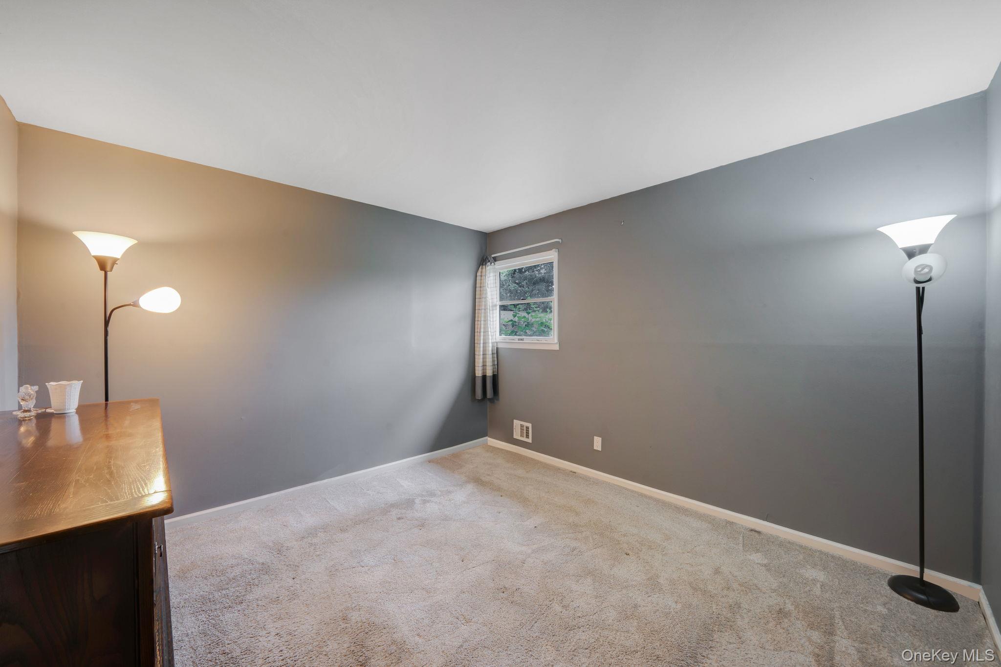 29 Franklin Street Islip, NY 11751 - Photo 25 of 39 a view of a room with a chandelier fan and a window