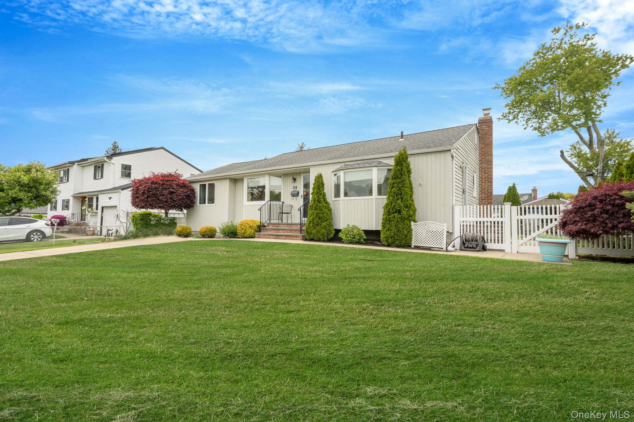 29 Franklin Street Islip, NY 11751 - Photo 3 of 39 a front view of house with yard outdoor seating and green space
