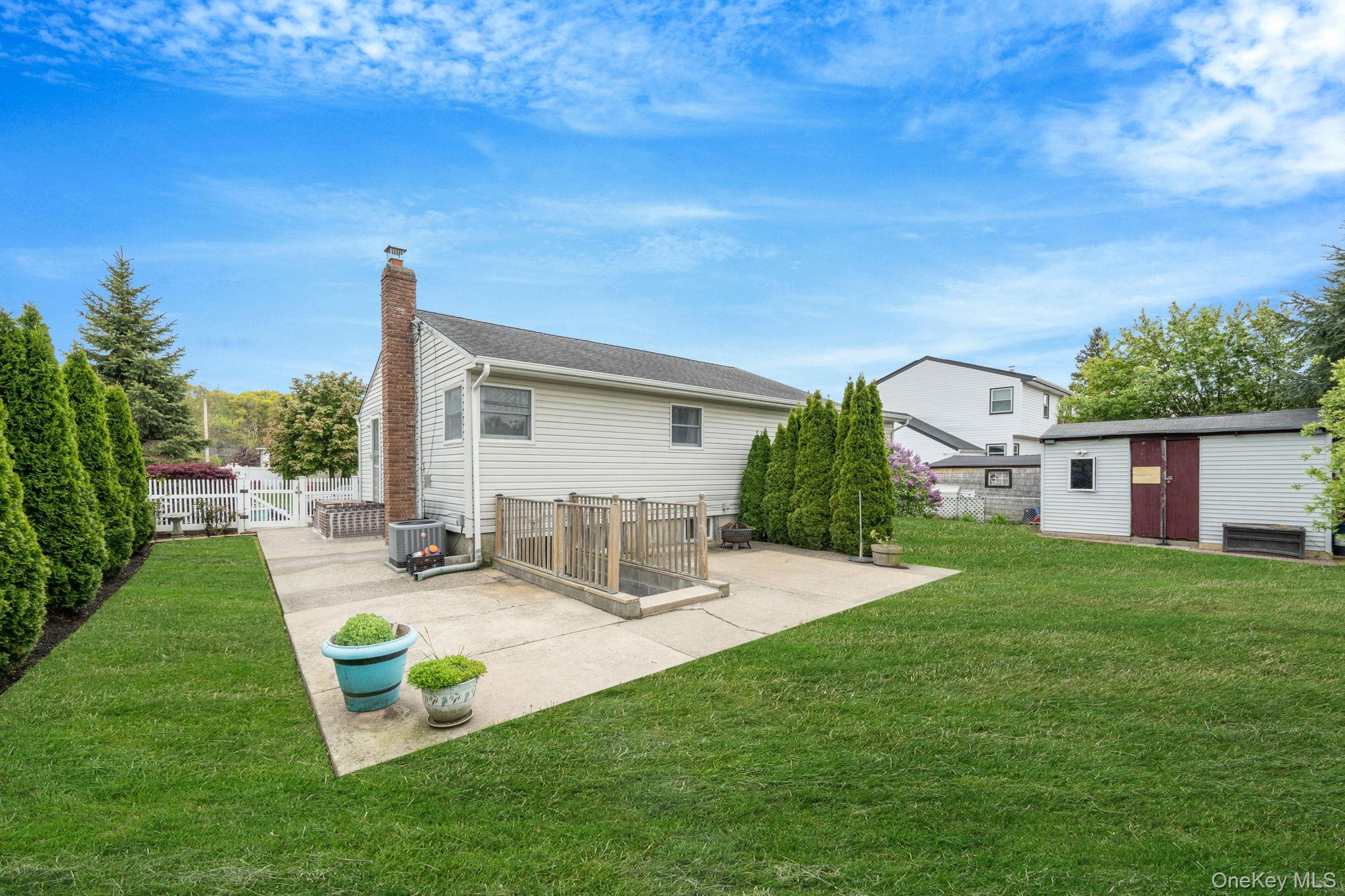 29 Franklin Street Islip, NY 11751 - Photo 31 of 39 a view of a house with backyard sitting area and garden