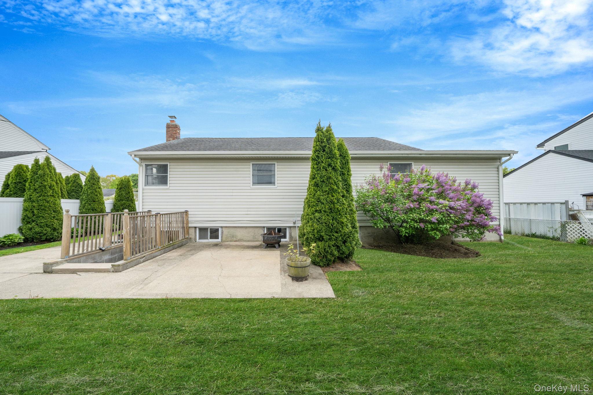 29 Franklin Street Islip, NY 11751 - Photo 32 of 39 a view of a house with a yard and sitting area