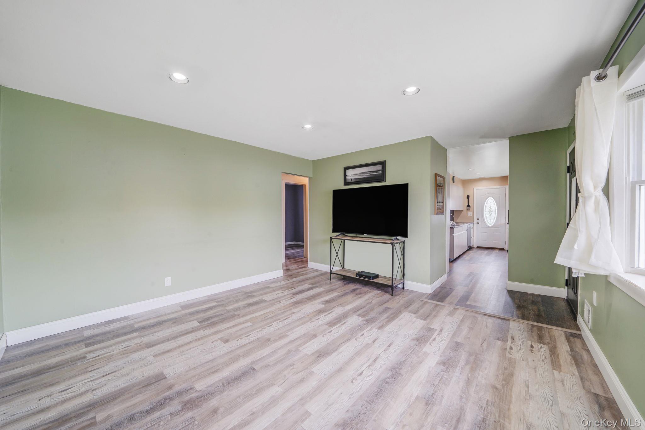 29 Franklin Street Islip, NY 11751 - Photo 7 of 39 a living room with furniture and a flat screen tv