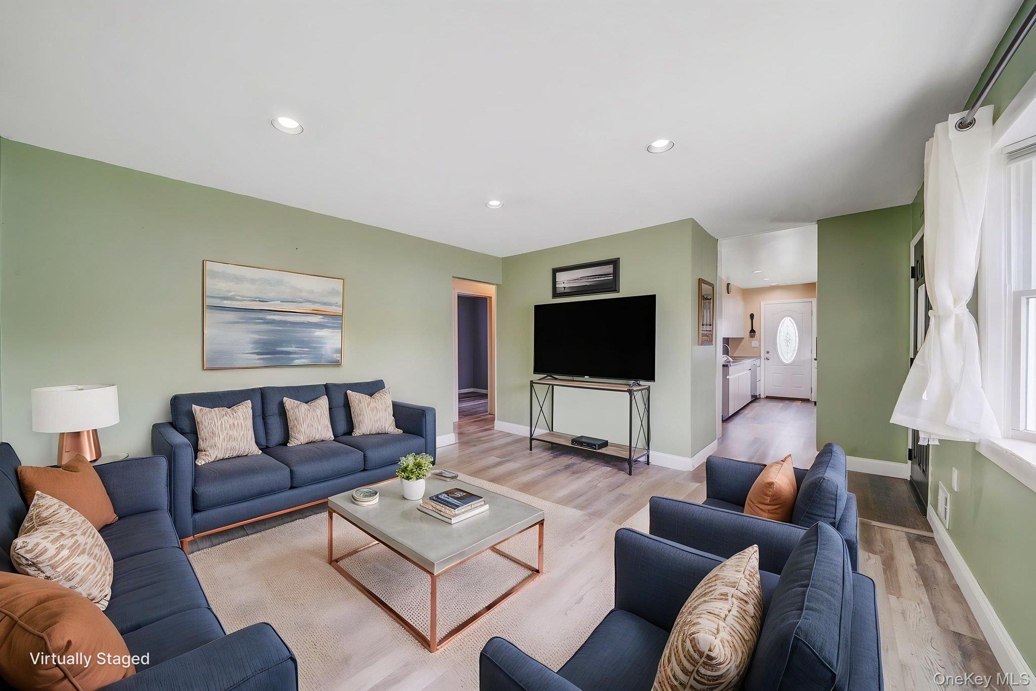 29 Franklin Street Islip, NY 11751 - Photo 8 of 39 a living room with furniture and a flat screen tv