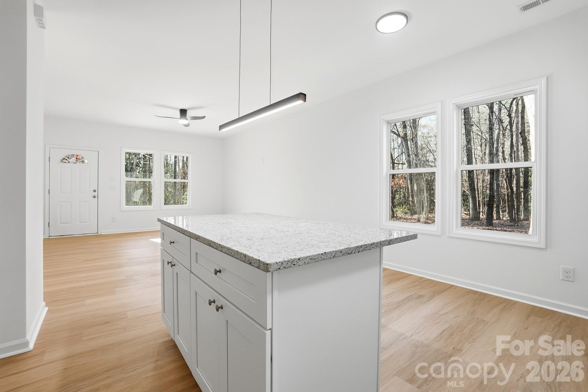 711 Adams Street Monroe, NC 28110 - Photo 14 of 25 a kitchen with granite countertop a stove and a window
