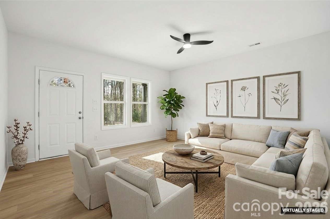 711 Adams Street Monroe, NC 28110 - Photo 2 of 25 a living room with furniture and a large window