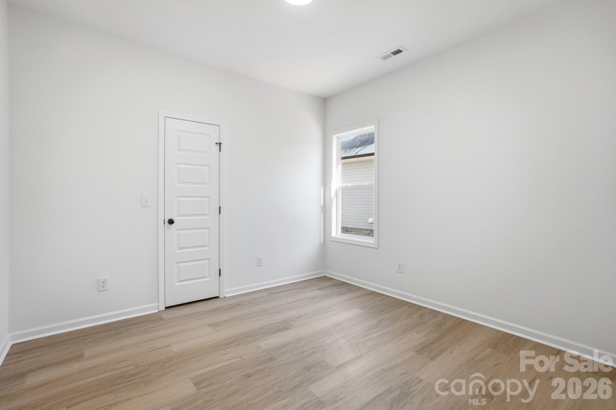 711 Adams Street Monroe, NC 28110 - Photo 22 of 25 an empty room with wooden floor