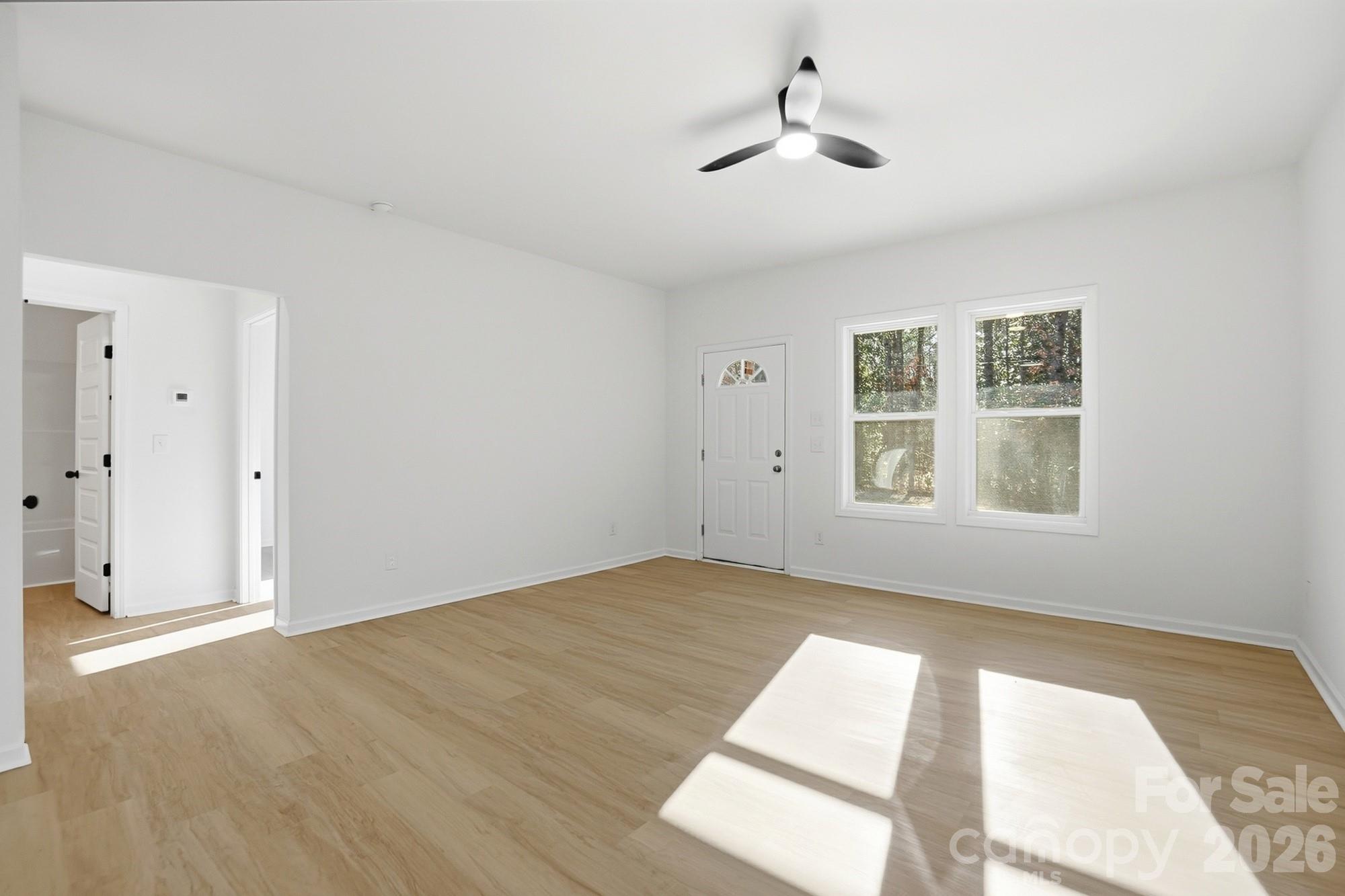 711 Adams Street Monroe, NC 28110 - Photo 5 of 25 a view of an empty room with windows