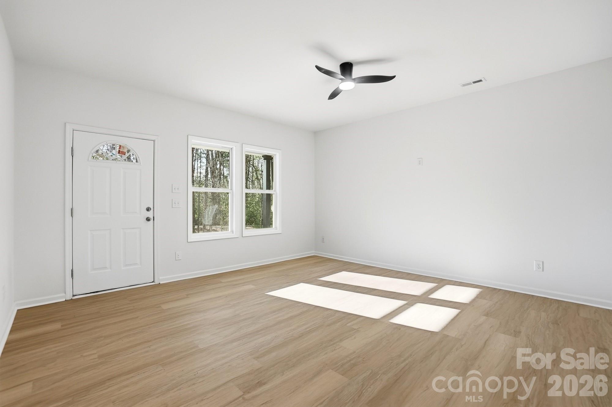 711 Adams Street Monroe, NC 28110 - Photo 6 of 25 wooden floor in an empty room with a window