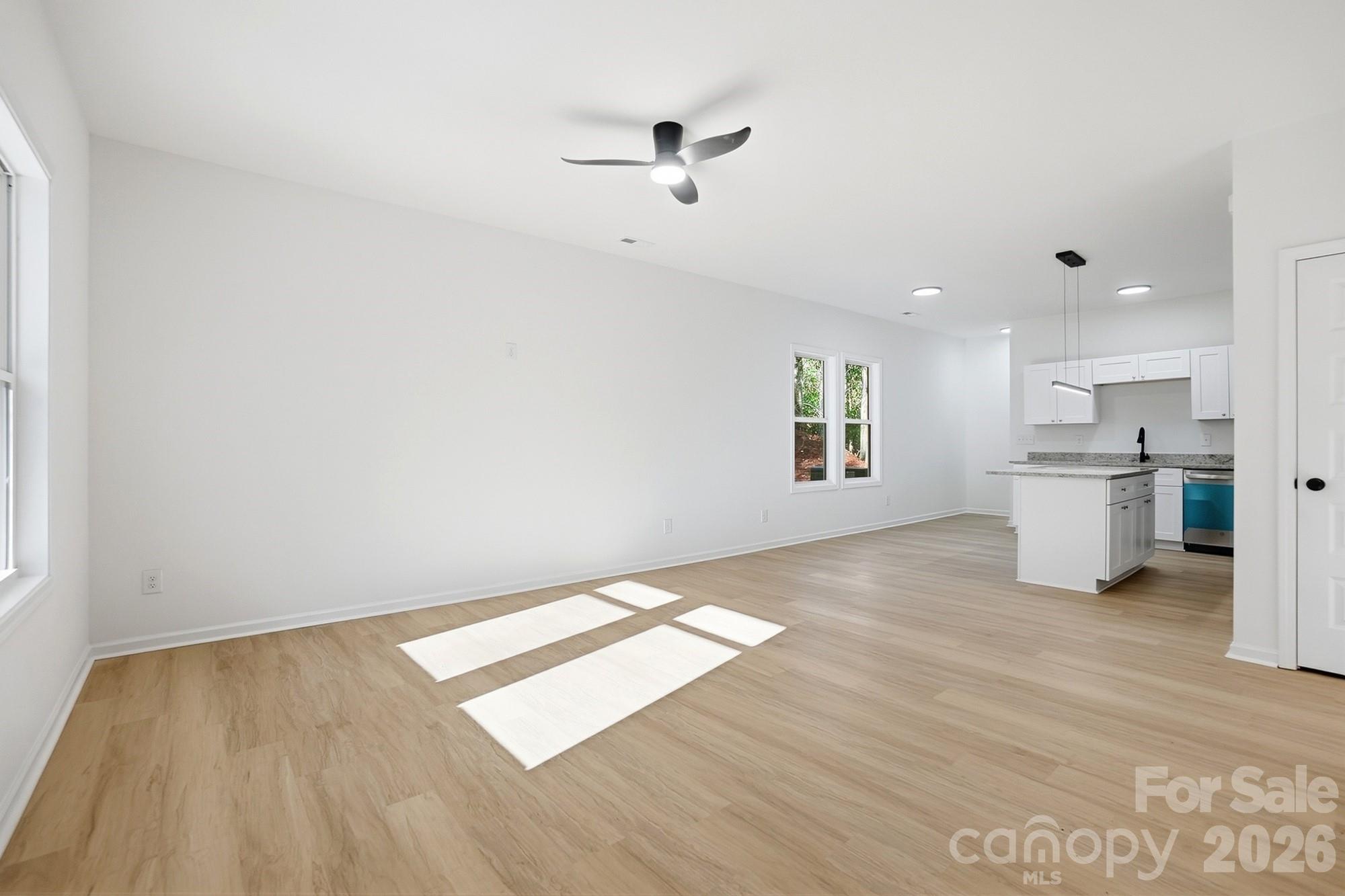 711 Adams Street Monroe, NC 28110 - Photo 7 of 25 wooden floor in an empty room with a window