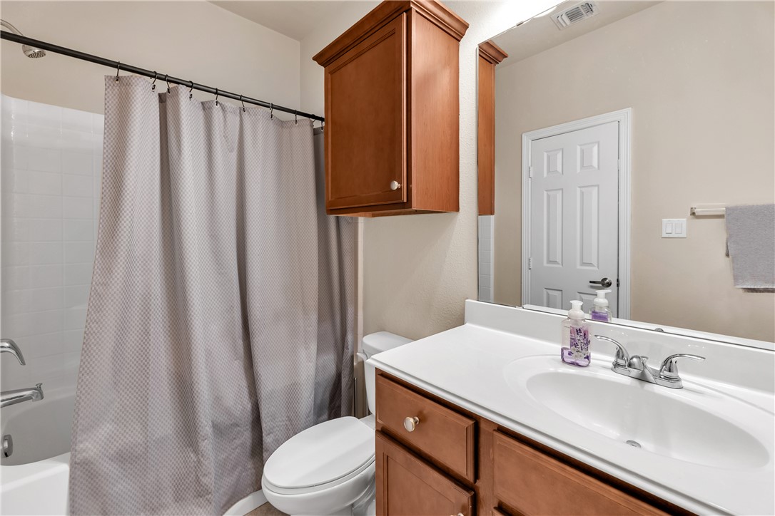 1198 Jones-Butler Road, Unit 2305 College Station, TX 77840 - Photo 11 of 25 a bathroom with a sink a toilet and shower curtain
