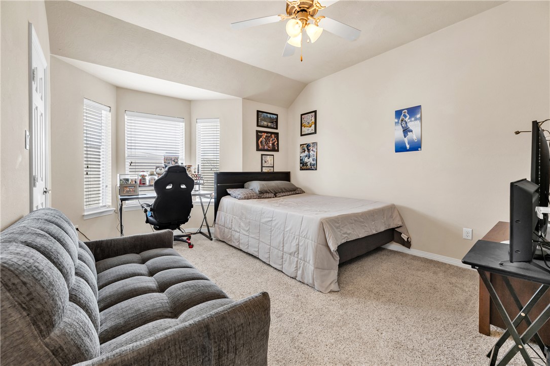 1198 Jones-Butler Road, Unit 2305 College Station, TX 77840 - Photo 17 of 25 a spacious bedroom with a bed couch and a window