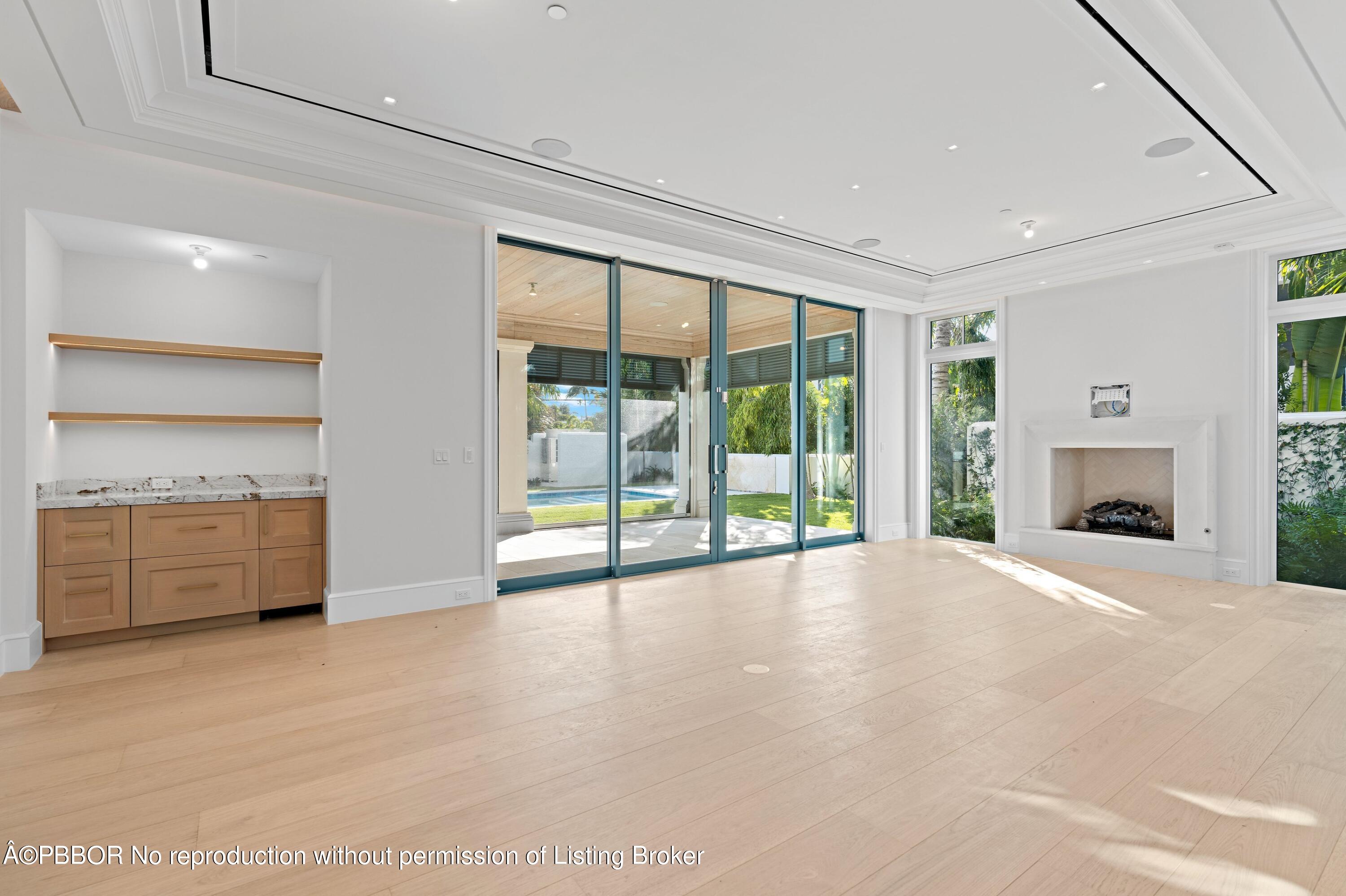 Undisclosed Address Palm Beach, FL 33480 - Photo 13 of 27 a view of an empty room with a fireplace and a window